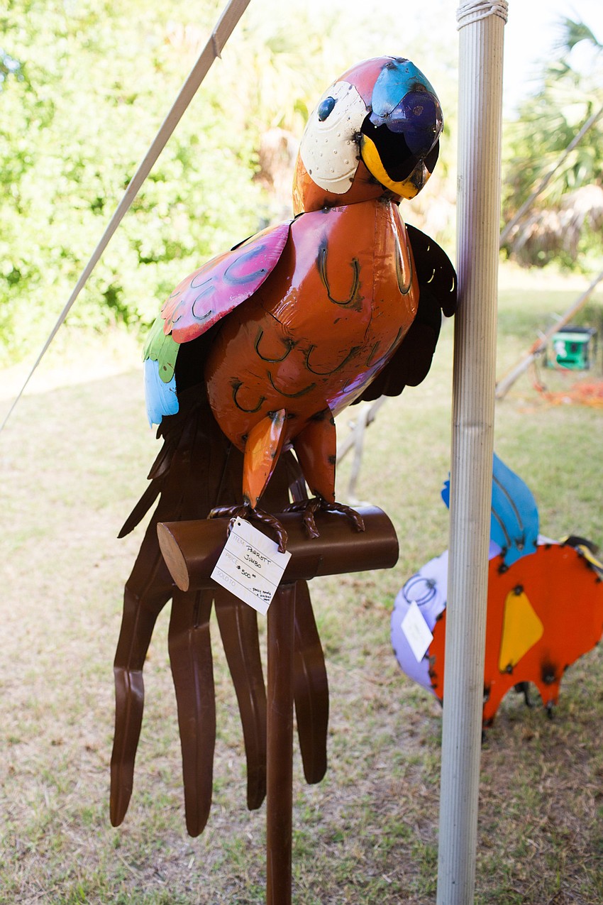 A large metal parrot decorates the outside edge of the tent.