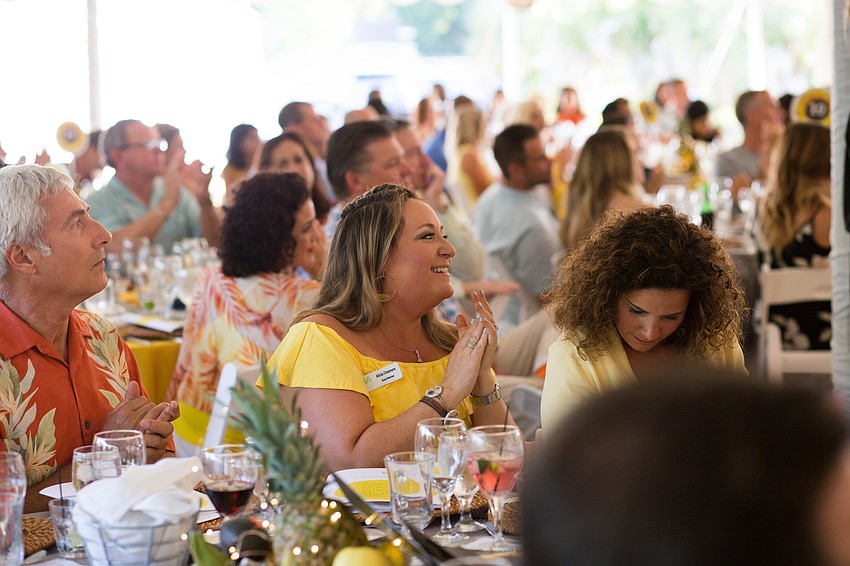 Board member Alicia Chalmers claps for the students.