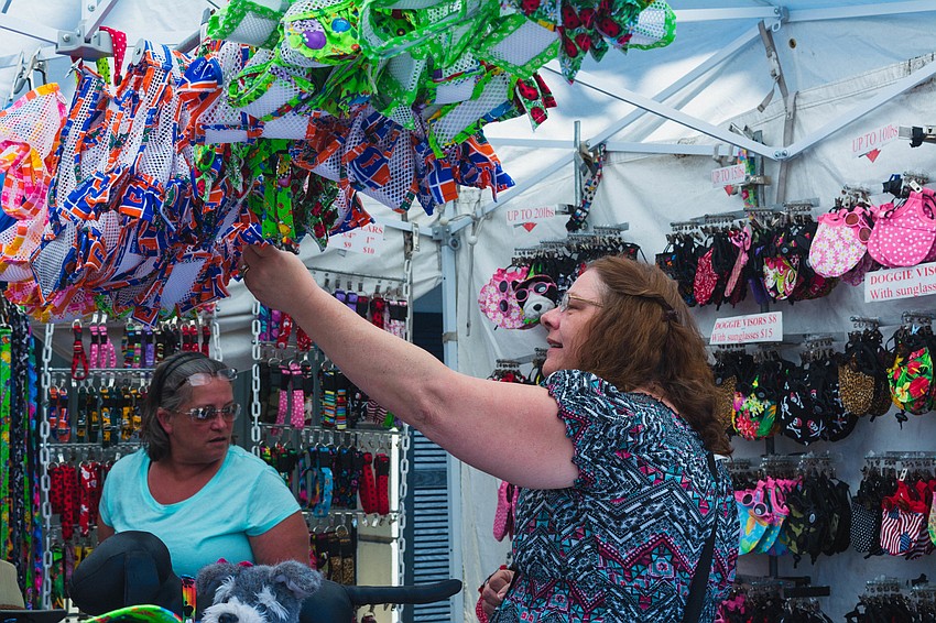 Dawn Lamay and Tammie Gollinger look through doggie harnesses at Siesta Fiesta.