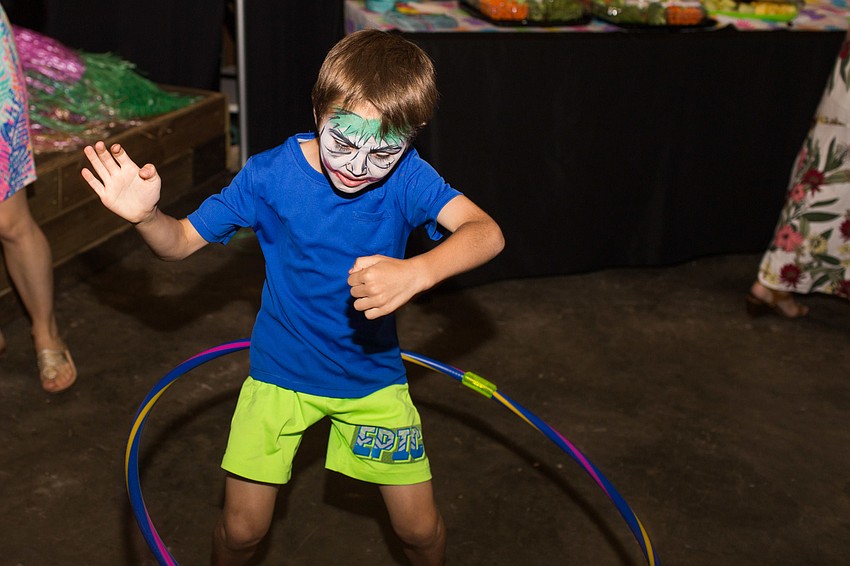 John Motzenbecker hula hoops on the dance floor.