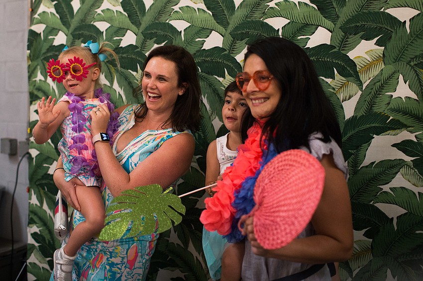 Chelsea and Genevieve Stickley and Jennifer and Vivian Masters pose in the photo booth.