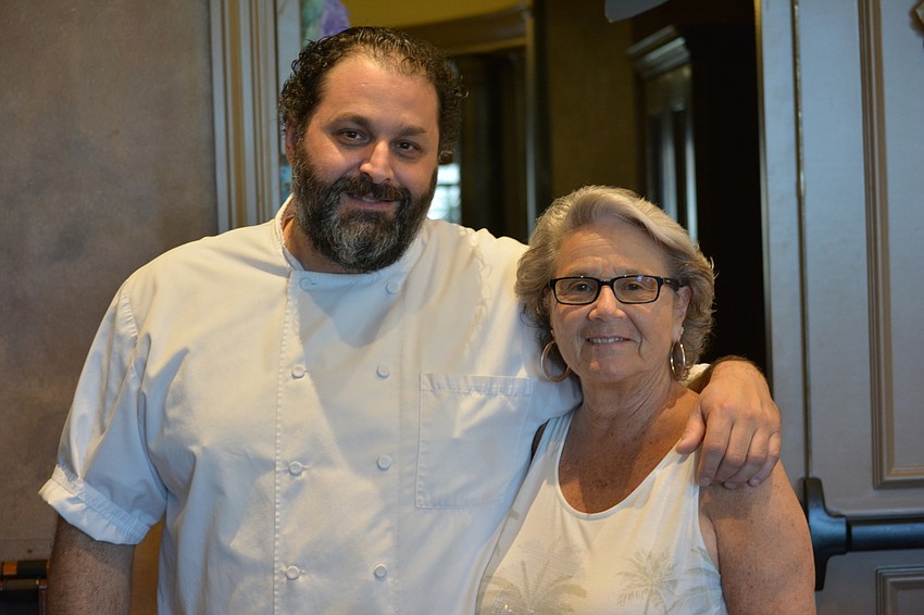River Strand Golf & Country Club Executive Chef Radames Febles visits with Eloise Eckler before the lunch.