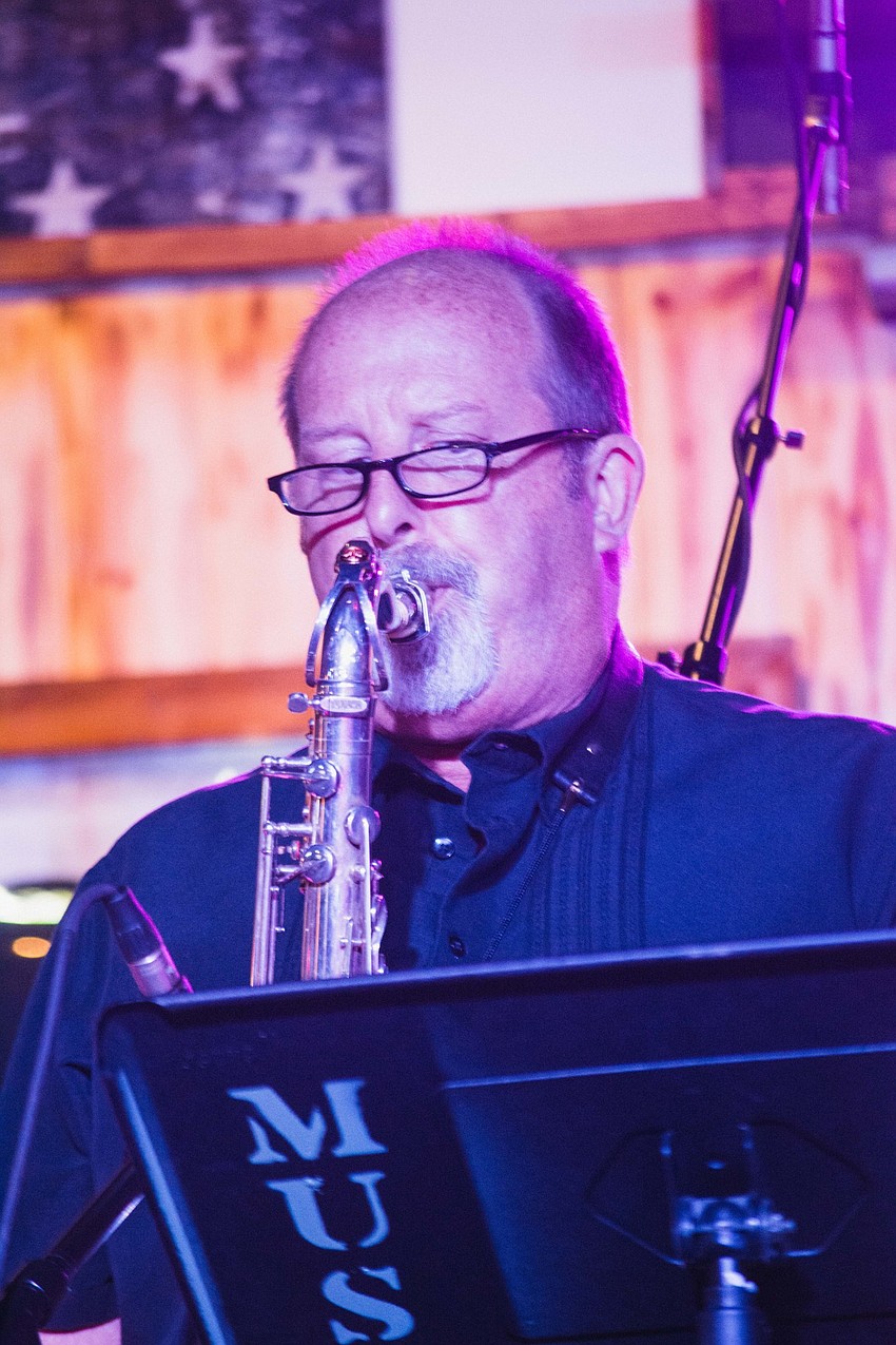 Doc and the Ear-iginals' saxophone player serenades the crowd.