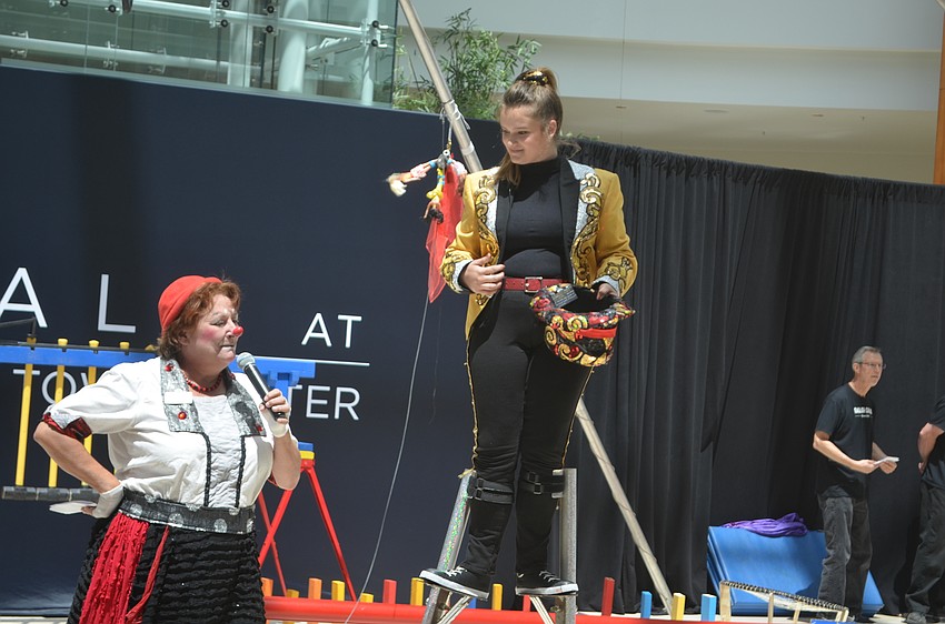 Karen Bell, the outreach education manager for Circus Arts Conservatory and Teagan Allen, a 10th-grader from Sarasota, entertain the crowd.