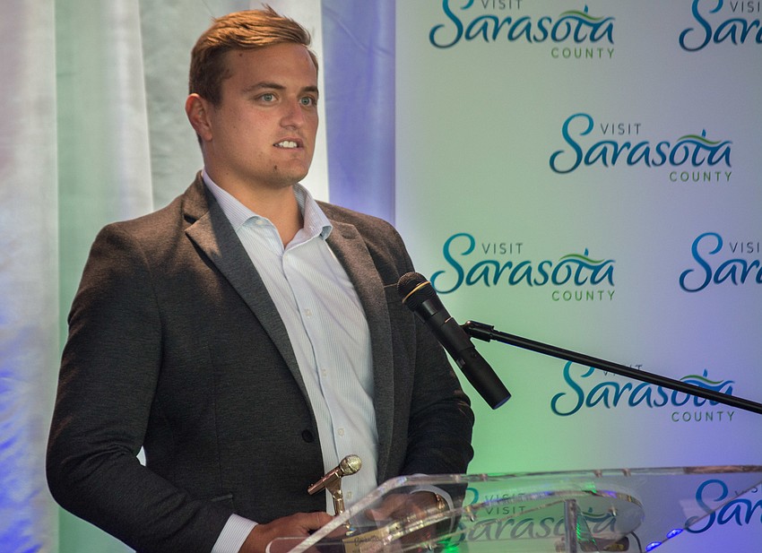Brad Satterlee accepts the Voices of Sarasota Award for the Ski-A-Rees.