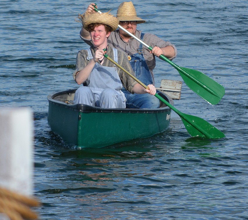 Casey Berkery, as Huck Finn, paddles to the shore with sound man Josh Linderman, who was recruited because The Players discovered at the last minute that Berkery had never been in a canoe.