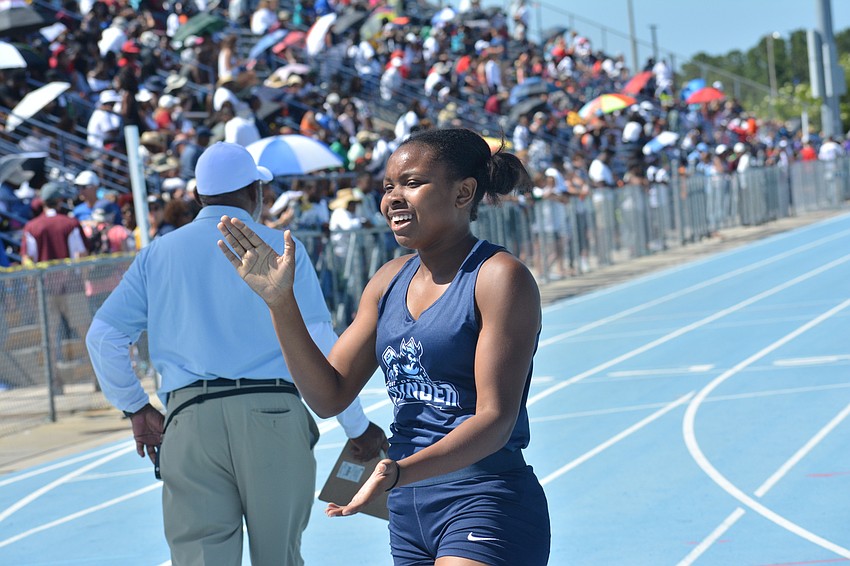 ODA's Saraiah Walkes claps after winning the 1A 200-meter dash preliminary race in 24.95.