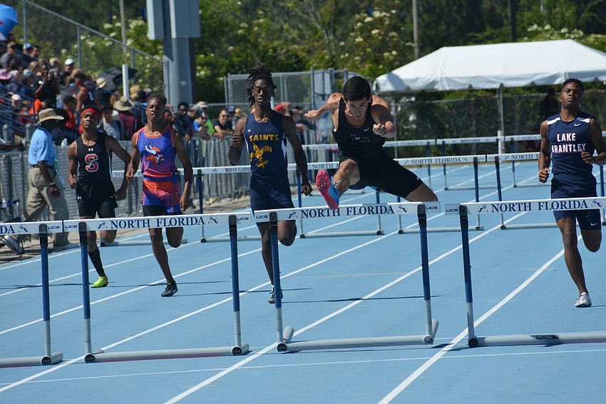 James Rivera masters the final leap in the preliminary 300-meter hurdles race. Rivera finished in 38.42 seconds, qualifying third.