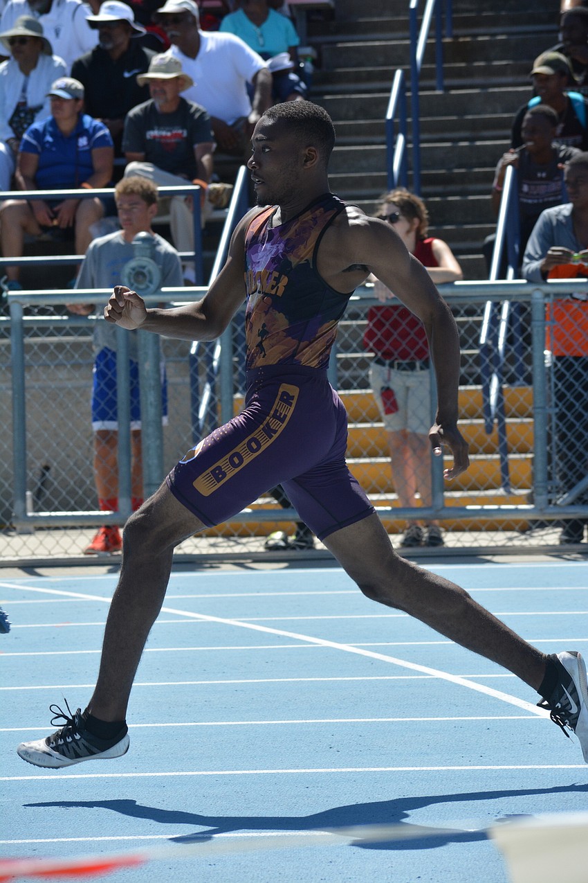 Booker High's Samauri Bane runs the 300-meter hurdles.
