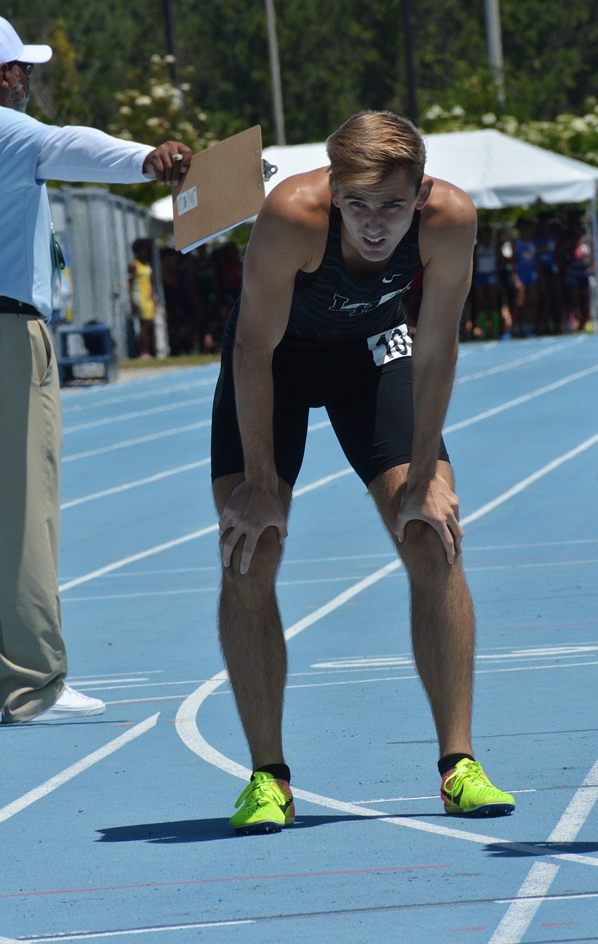 Lakewood Ranch senior Andrew Dean leans over to breathe following the 4A boys 800-meter race.