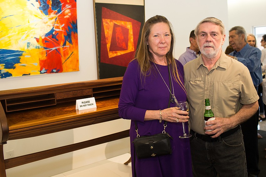 Sandy and John Dalton with John's handmade desk.