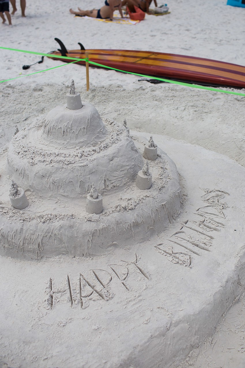 A birthday cake sculpture was front and center on the beach.