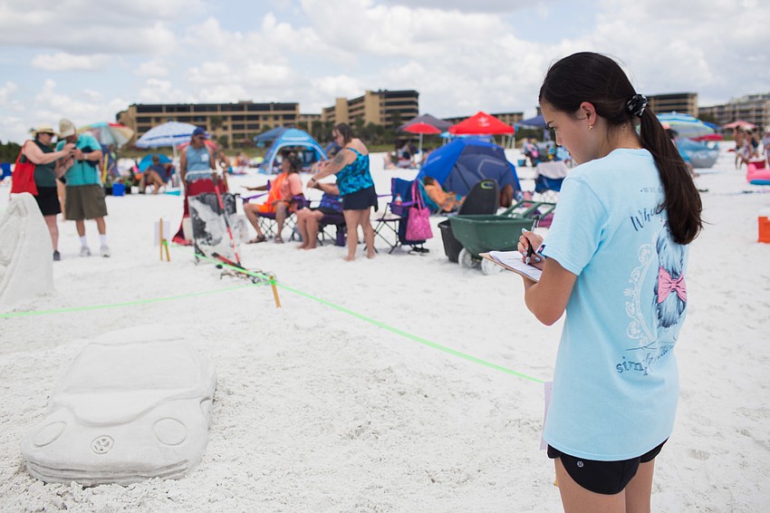 Kelsey Blanchard judges the sculptures.