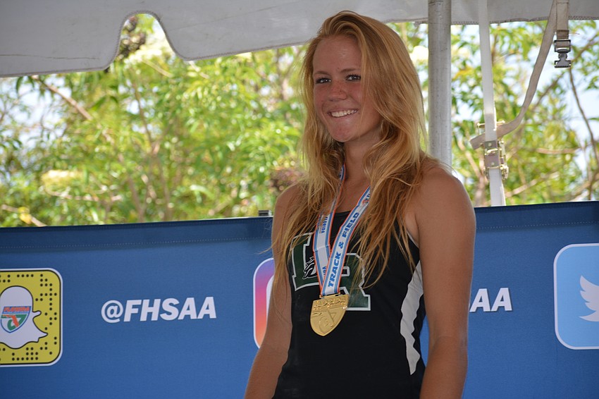 Karen Kay Lyvers shows off her 4A girls pole vault gold medal.