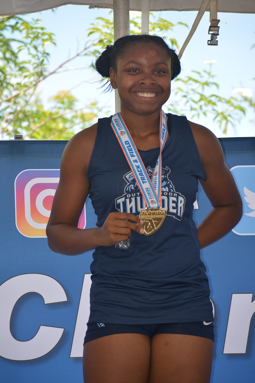 ODA freshman Saraiah Walkes flashes her gold medal after winning the 1A girls 100-meter dash (12.18 seconds).