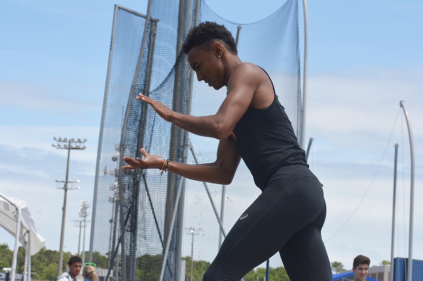Jaasiel Torres claps after taking home the 4A boys high jump title.