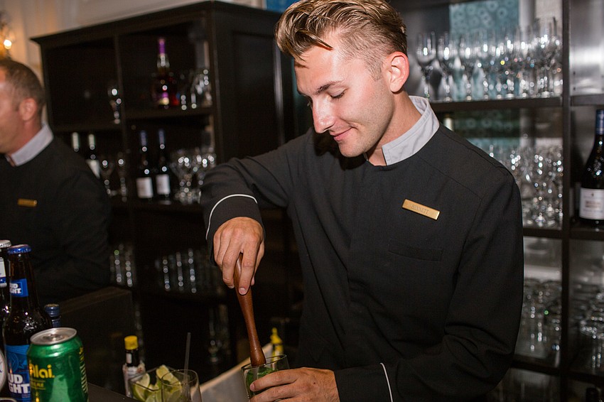 Bennett Eppinger makes mint juleps for guests.