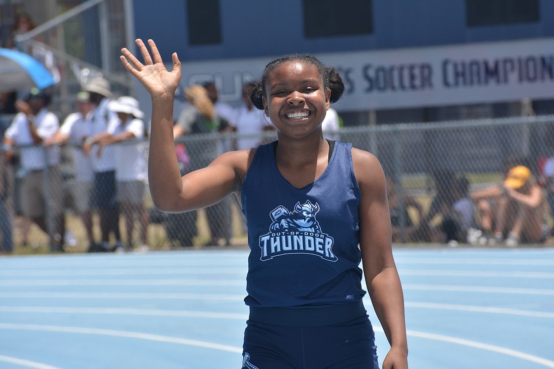 ODA freshman Saraiah Walkes waves to the crowd after winning the 1A girls 100-meter dash (12.18 seconds).
