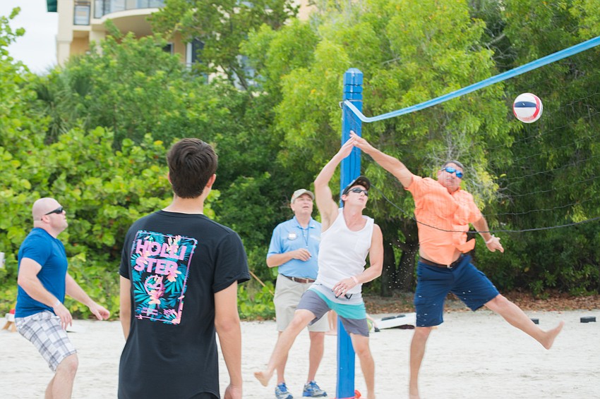 Longboat Key fire and police departments compete in a game of volleyball.