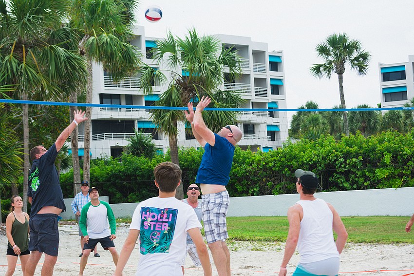 Longboat Key fire and police departments compete in a game of volleyball.