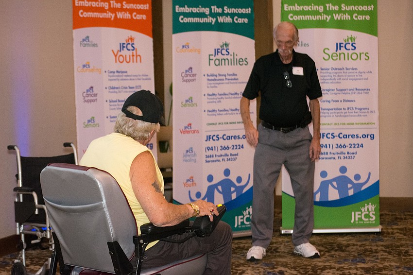Veteran Ed Talhurst tests out his    customized power wheelchair given to him by Wheels 4 Purple Hearts CEO Jack Thompson.