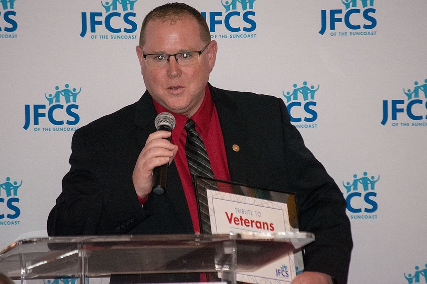 Christopher Nothdurft accepts his community service award.