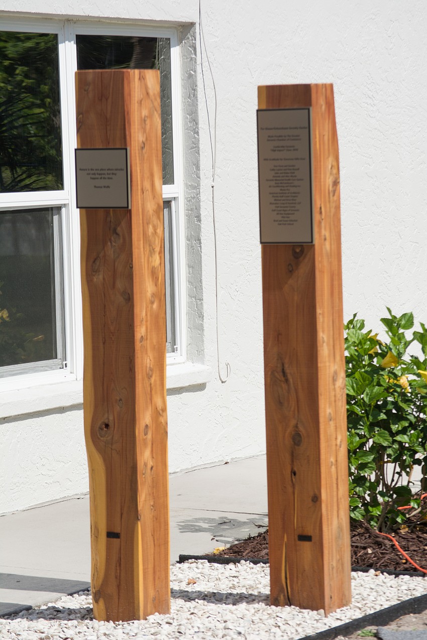 Two poles feature a quote about nature by Thomas Wolf.