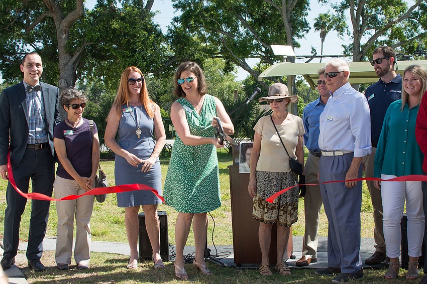 Glasser Schoenbaum Human Services Center CEO Kameron Partridge Hodgens cuts the ribbon during the dedication ceremony of the Serenity Garden.