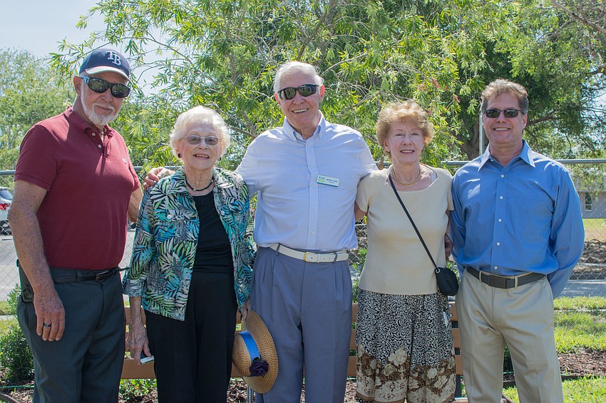 David Kidd, Judy Stroke, John E. Kidd, Elaine Kidd and David Kidd stand in front of a bottle brush tree dedicated to their family member Cynthia Kidd, who passed away last year.