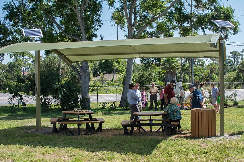A shade structure with picnic tables provides a place to eat and relax in the Serenity Garden.
