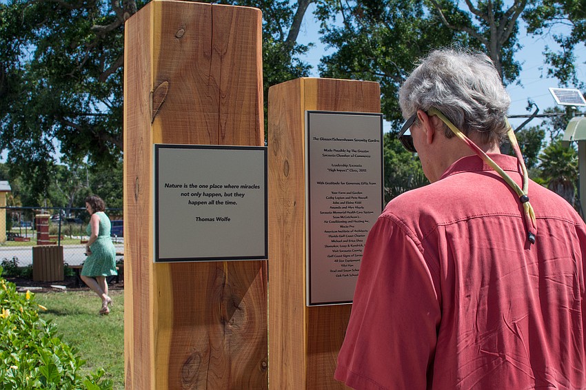 A Thomas Wolf quote about nature is featured on one of the garden's wood poles.