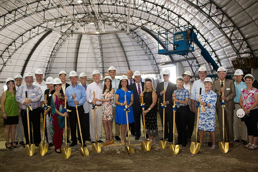 Those involved with the renovation project pose for a photo with the golden shovels.