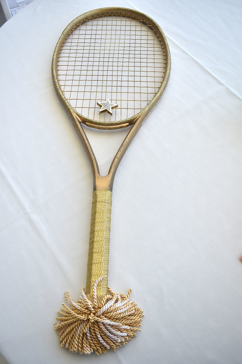 Robert Ruff was given this golden racket in honor of his 90th birthday.