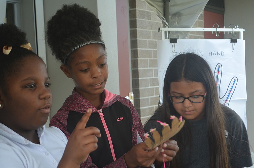 Demari McCledon, Sharonda Pommells and Aliza Lara, fifth-graders, made interactive models of the how the nervous system to demonstrate to younger students.