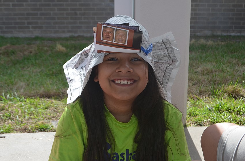 Genesis Pacheco, a fifth-grader, goofed on at one station and made a hate out of old newspaper that she got to wear the rest of the day.