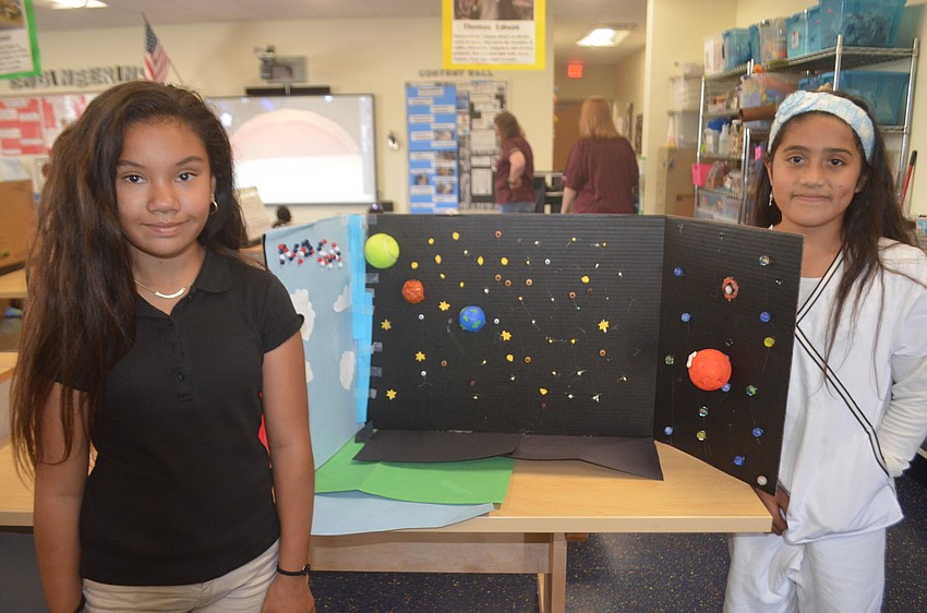 Kylie Babas and Ixelt Amezcua, fourth-graders, made the set they're posing next to for the claymation movie shown during the showcasing.