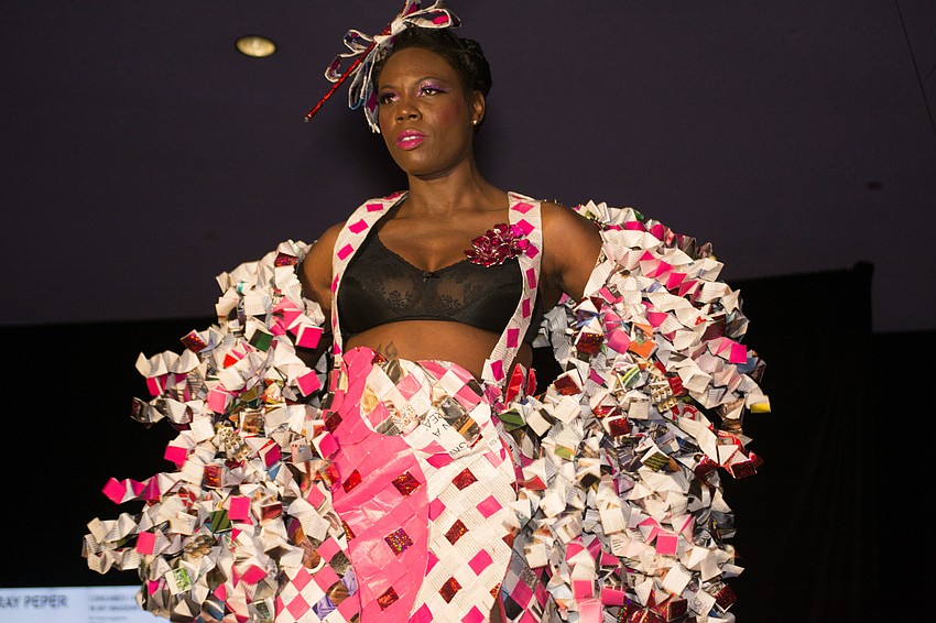 Gwen Cooke models a look made out of gift wrap and newspaper by Ray Peper.
