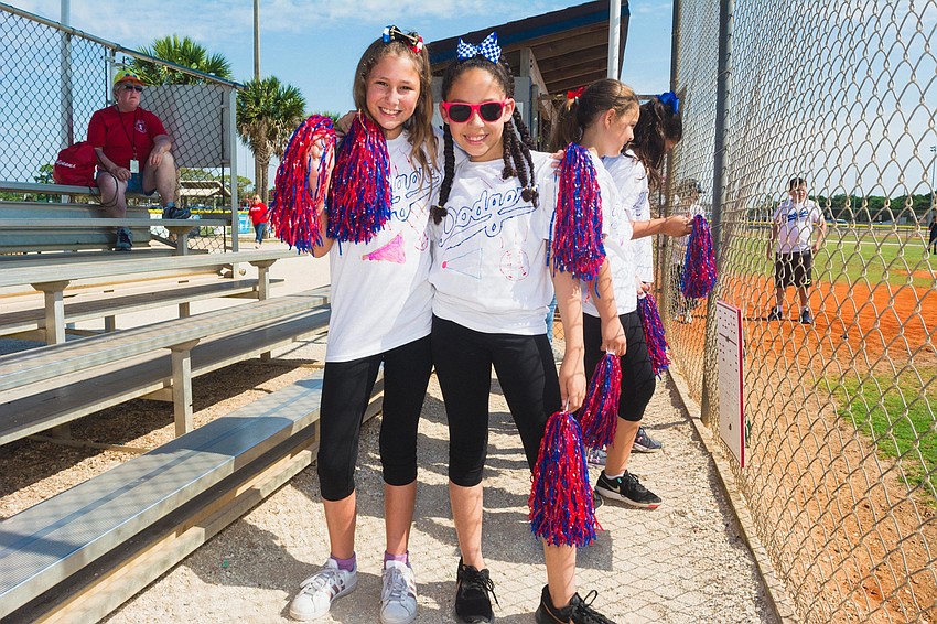 Sarah Pryor and Mya Merrick cheer for the Los Angeles Dodgers.