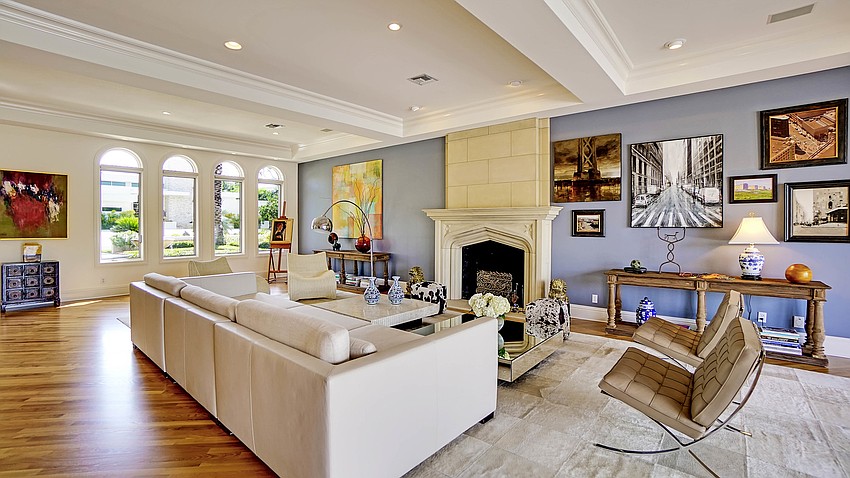 The living room features hardwood floors and windows provide ample natural lighting.