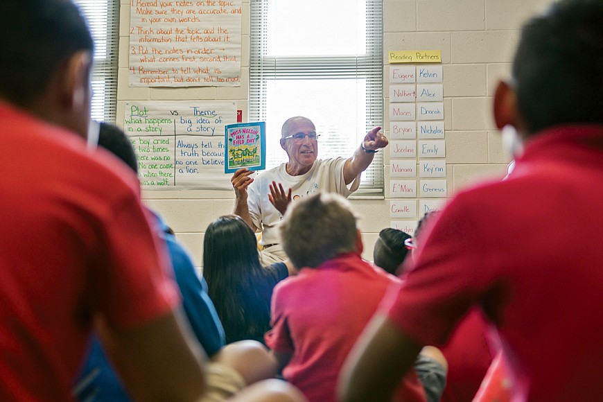 Vince Cera reads to second-graders at Palmettoâ€™s James Tillman Elementary School.