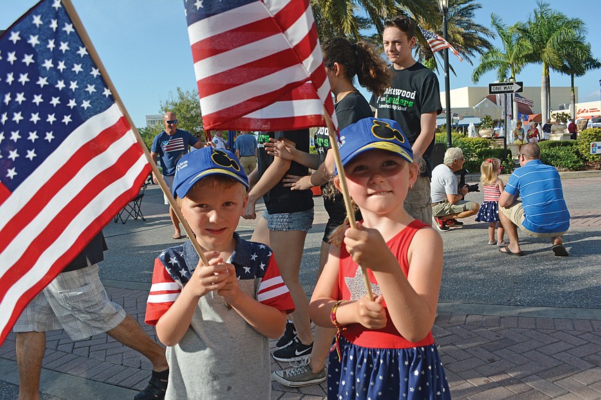 Zander and Zella Ribar, both 4, present the colors at last yearâ€™s Tribute to Heroes Parade.