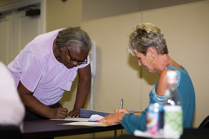 Laurel Civic Association Executive Director Sandra Terry signs for the grant.