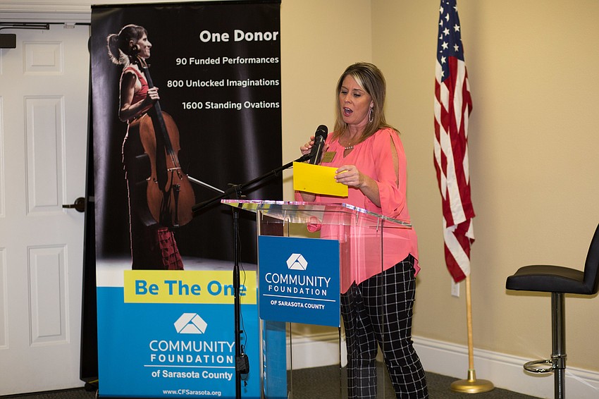 Just For Girls representative Ann Colonna reads the name of the next organization.