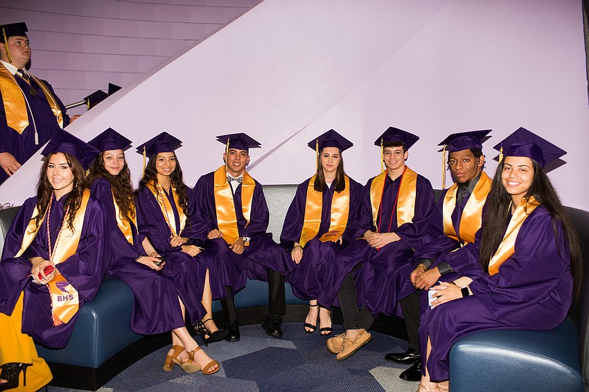 Graduates smile for the camera as they wait to line up.
