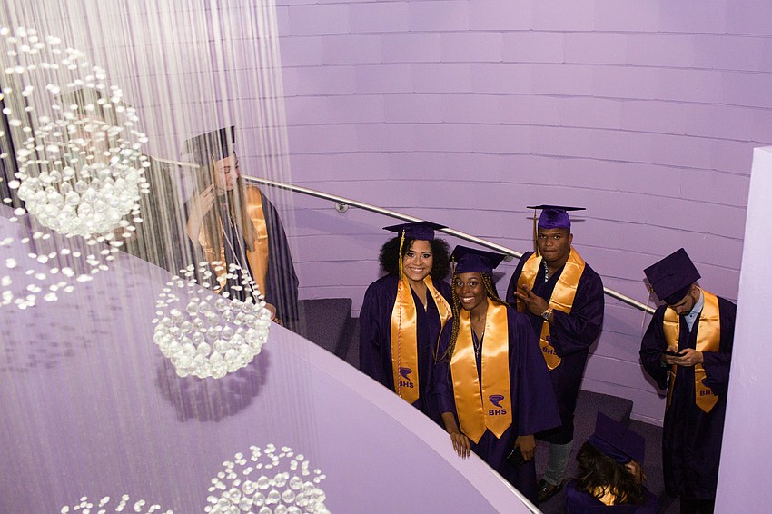 Two students smile for the camera as they line up.