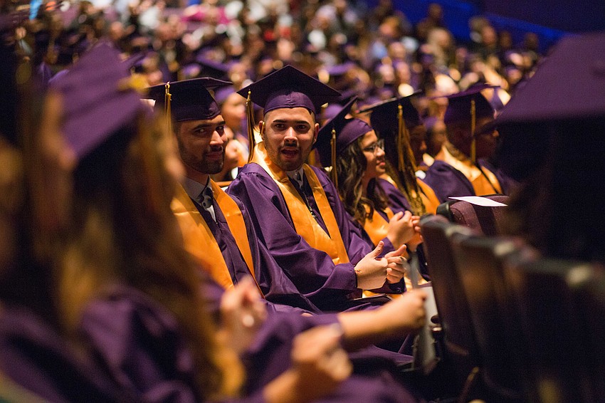 Students eye another student from across the row as they dance to the music.