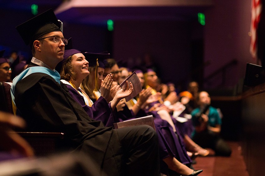 Students smile as they watch the musical performance.