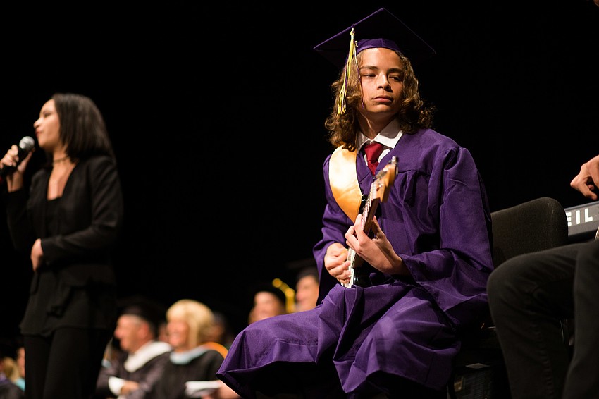 A student plays the guitar during the performance for 