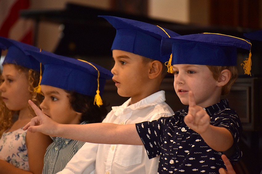 The graduates sing “He’s Got the Whole World in His Hands,” “Make New Friends” and “The Kindergarten Song” for their parents.