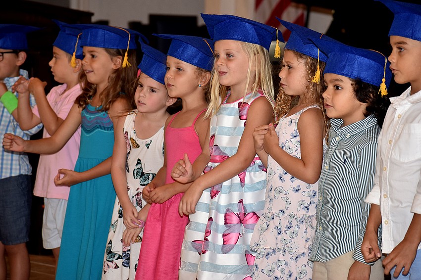 The graduates sing “He’s Got the Whole World in His Hands,” “Make New Friends” and “The Kindergarten Song” for their parents.